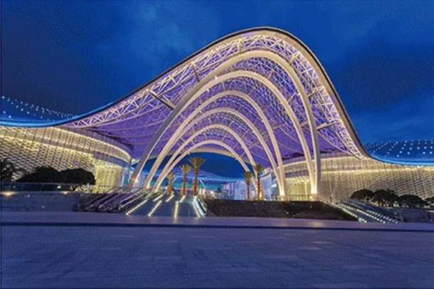 Night view of a large aluminium-clad architectural canopy